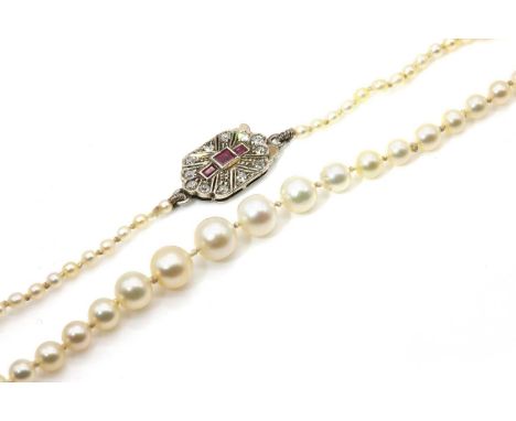 A single row graduated pearl necklace,with a single row ruby and diamond safety clasp, 142 pearls, 2.00 to 6.10mm in size, st
