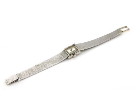 A ladies' 18ct white gold Delano diamond set mechanical cocktail watch, c.1970,with a rectangular silvered dial, black batons