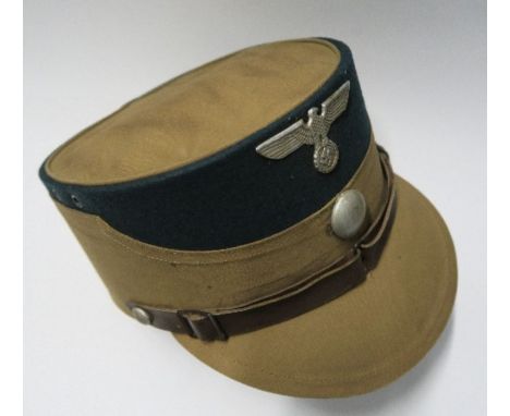 A WW2 style German army kepi, in tan cotton fabric, with an emerald green felt top and silver button on the front, interior l