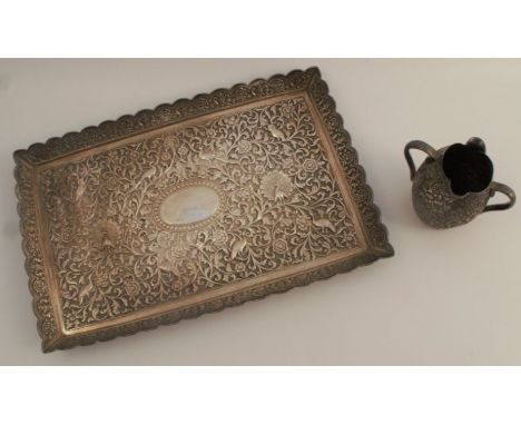 An Oomersi Mawji Indian silver tray, of rectangular form, heavily decorated with birds, leaves and flowers, weight 13oz, 11in