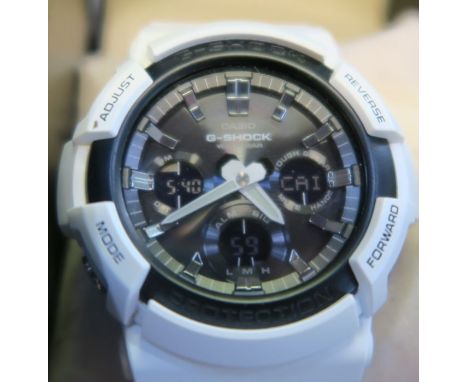 A Casio G-Shock wrist watch in white, with case