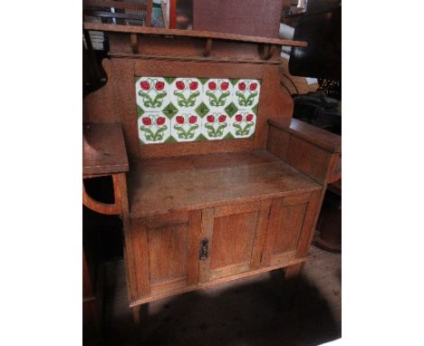 An Arts and Crafts style tile backed wash stand, with cupboard door below, width 41.5ins x height 53ins