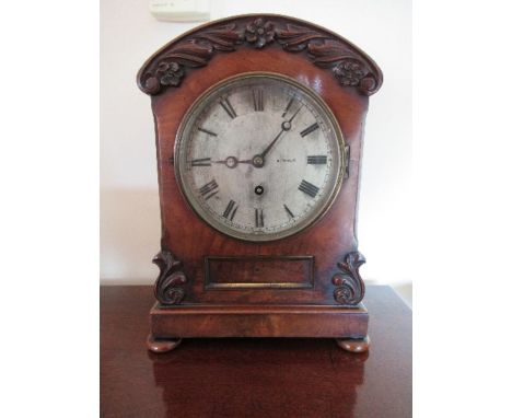 A 19th century mahogany bracket clock, the circular silvered dial below a domed top hood, and raised on a plinth, inscribed K