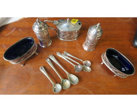 A silver five piece cruet set, with pierced decoration, Chester 1898, together with three hallmarked silver condiment spoons 