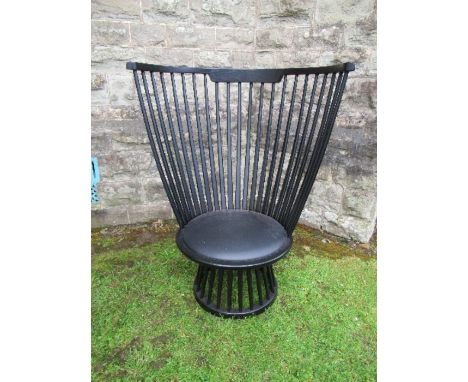 Ebonised high comb back chair of inverted pyramid form.