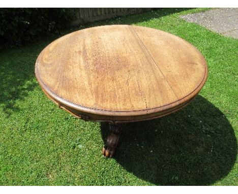 A Victorian circular mahogany breakfast table, raised on an ornate carved pedestal, terminating in a similarly carved tripod 