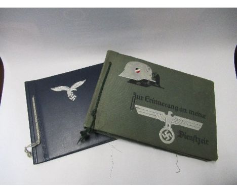 Two Third Reich style photograph albums, one green with a silver image of a helmet and RMBO logo to the cover, containing ima