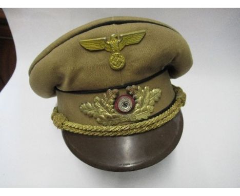 A Third Reich style Gauleiter's visor cap, in light brown cotton with matching hat band and black piping, gold coloured braid