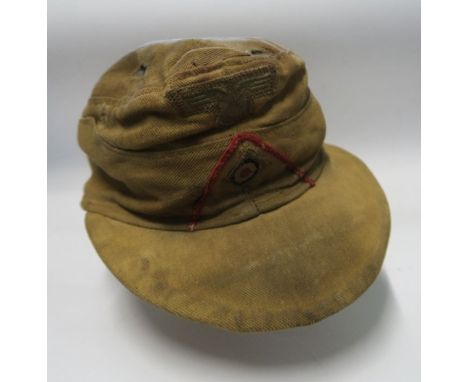 A 1942 German Afrika Korps style M43 desert field cap, the red interior stamped Rb Nr 003 1942, 57, together with a&nbsp;Germ