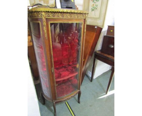 FRENCH DESIGN VITRINE, bow fronted with pierced gilt metal marble topped gallery, bow fronted central door with red plush int