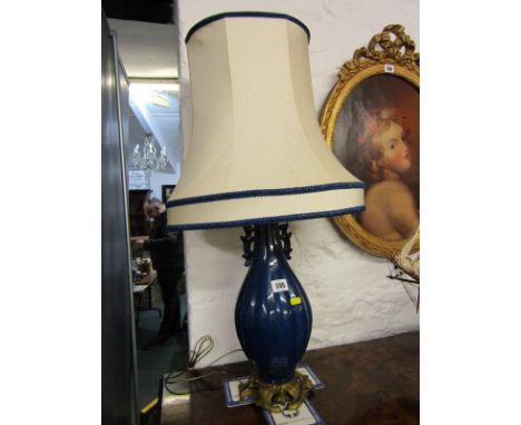 LIGHTING, a Chinese style blue ground ceramic table lamp with brass scroll base and mounts with shade, 15" height 