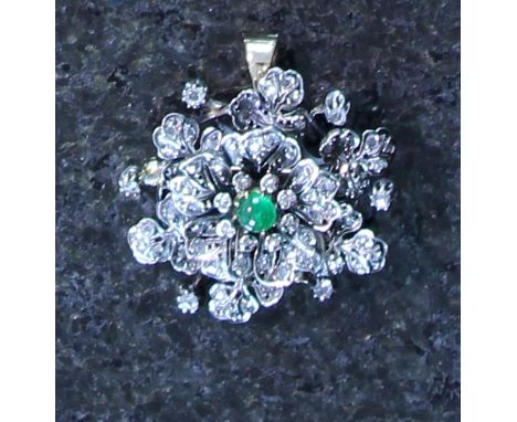 An Antique 19th Century Emerald & Diamond pendant / brooch in yellow gold and silver, modeled as a flower, the central caboch