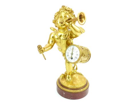 French 19th C mantel clock, gilded winged cherub blowing a trumpet with drum clock to his hip, red marble base, eight day clo