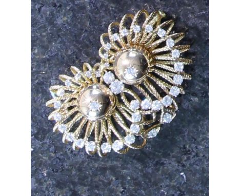A vintage diamond brooch in high carat yellow gold, centred by two central orbs, each crowned with a round brilliant cut diam