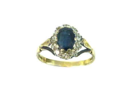 Diamond and sapphire cluster ring, the central oval cut sapphire approx. 7 x 5mm fringed by a border of ten diamonds, 18ct go