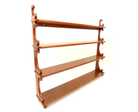 Victorian mahogany four tier shelf, with c-scroll support and graduated shelves, raised on ball feet, 102.5cm h, 122cm w