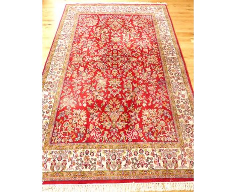 Large Keshan carpet,floral design over red ground and cream borders, 325x 200cm