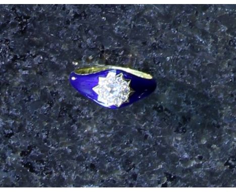 An antique diamond and enamel ring in yellow gold. The central round cut diamond set in a star motif, surrounded by smaller r