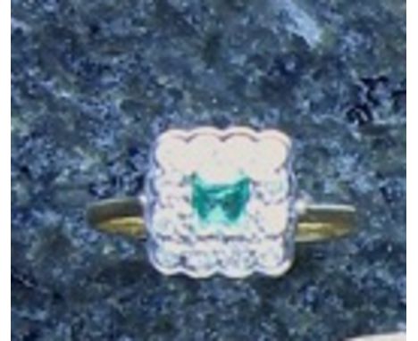 An emerald and diamond ring in high carat yellow gold, the central square cut emerald, weighing approx. 0.21ct surrounded by 