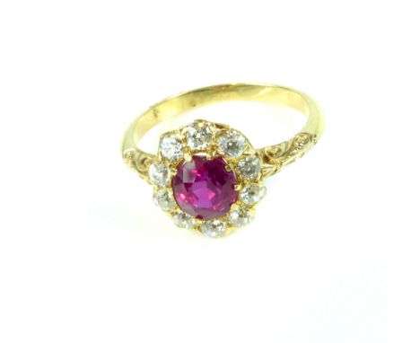 An antique Victorian Burmese ruby and diamond cluster ring in yellow gold, the central ruby weighing 1.35ct, surrounded by a 