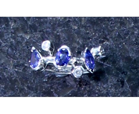 CARTIER 'Meli Melo' sapphire and diamond ring in platinum, the three sapphires, one pear, one oval and one marquise cut, set 