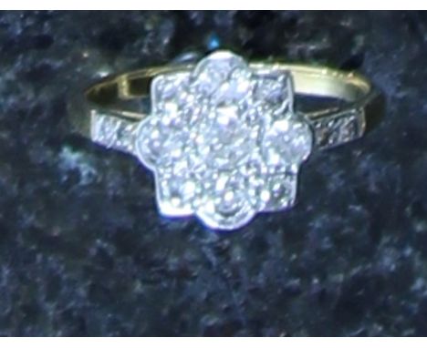 An antique diamond cluster ring in 18ct yellow gold, the four large round cut diamonds cornered by smaller round cut diamonds