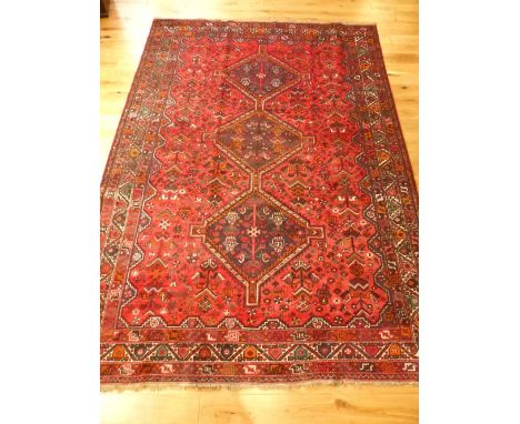 Caucasian carpet, stepped three pole medallion to centre over stylised floral and geometric red ground, 305x 214cm