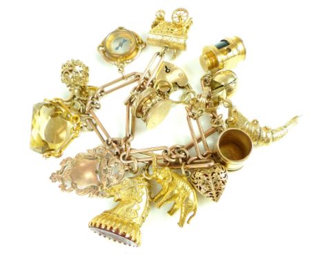 9ct gold charm bracelet with 15 gold charms including horse head, lantern, carriage, merry-go-round, ring in casket and compa