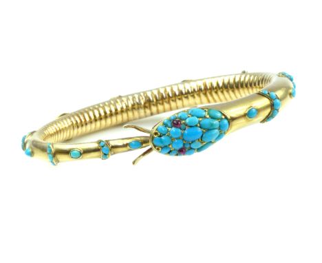 ROYAL PROVENANCE An antique ruby and turquoise snake bangle in high carat yellow gold, the snake modelled eating its own tail