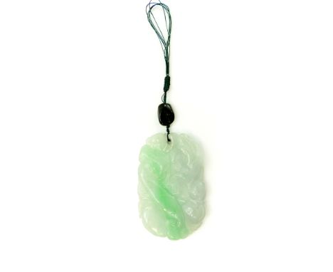 A Chinese Jade Pendant of rounded rectangular form, deeply carved to both sides with depictions of birds and nature. Length 6