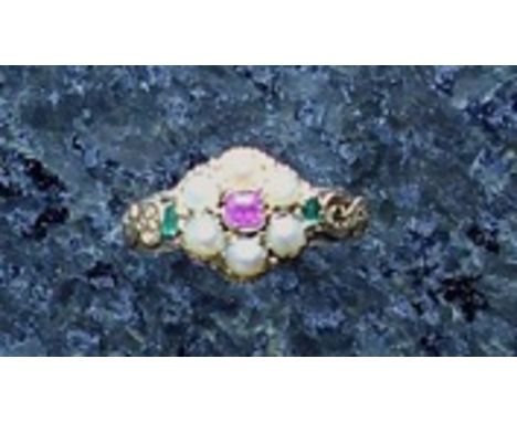 An antique Victorian ruby, emerald and seed pearl cluster ring in high carat yellow gold, the central round cushion cut ruby,