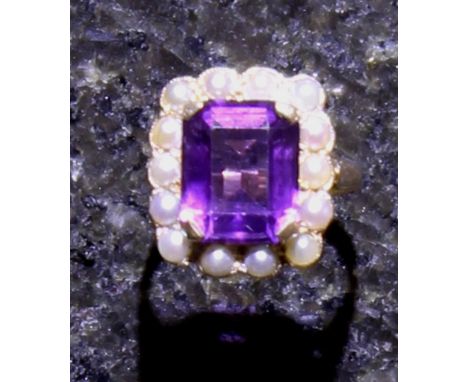 An antique amethyst and seed pearl cluster ring in 9ct yellow gold, the central cushion cut amethyst, weighing approximately 