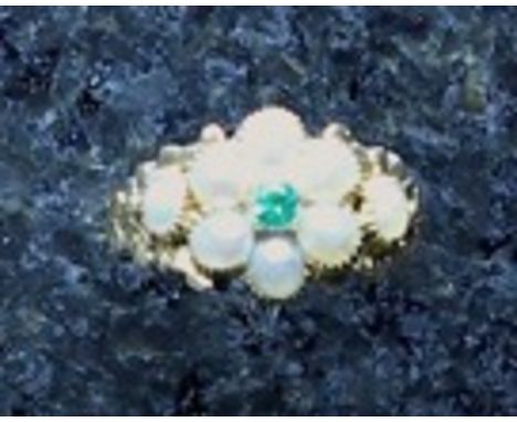 An antique Victorian emerald and seed pearl cluster ring in high carat yellow gold, the central emerald surrounded by seed pe