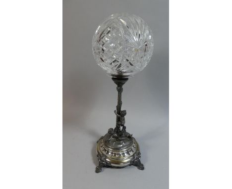 A Silver Plated Table Lamp with Cut Glass Shade, the Support in the Form of a Palm Tree Being Climbed by Cherubs, 42cm High 