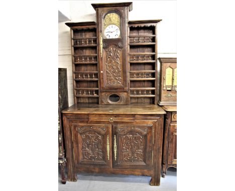 Antique French oak vaisselier a horloge, the boarded shelf back with integral comptoise clock and a carved panel door, the ba