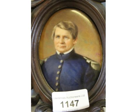 Oval miniature painting on porcelain, portrait of a military gentleman, period carved wood frame, indistinctly signedPossibly