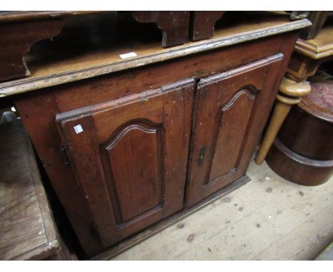 18th Century French cherry wood cupboard, the moulded top above two arch panel doors enclosing shelves, on a moulded plinth b