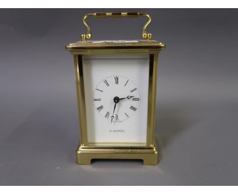 20th Century brass cased carriage clock with enamel dial inscribed H. Samuel, together with a brass anniversary clock under g