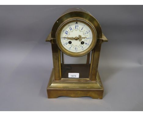 Early 20th Century brass cased mantel clock, the dome shaped case with enamel dial, Arabic numerals and bevelled glass door a