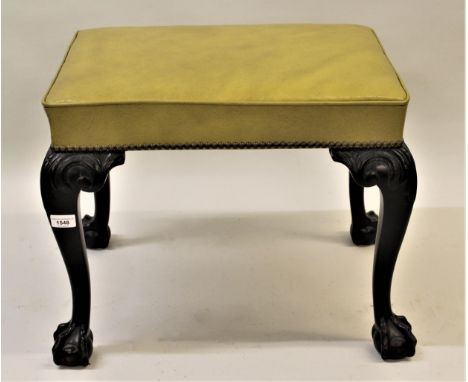 Rectangular green leather upholstered and mahogany footstool in Chippendale style, raised on carved cabriole claw and ball su