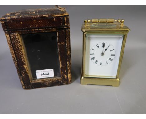 Gilt brass cased carriage clock, the enamel dial with Roman numerals, the two train movement striking on a gong, together wit