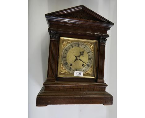 Edwardian walnut cased two train mantel clock of architectural form, the gilt dial with a silvered chapter ring and Roman num