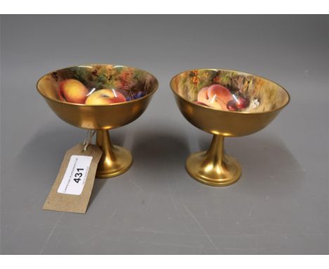 Pair of Royal Worcester pedestal cups internally painted with fruits, one by Ricketts, the other by Price, the exteriors gild