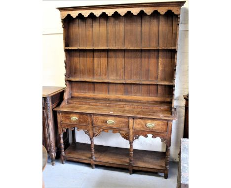 George III oak dresser, the boarded shelf back above three drawers, raised on turned supports with an open shelf base, 60ins 