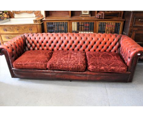 20th Century red leather upholstered Chesterfield three seat sofa, with pair of matching armchairs, having red damask upholst