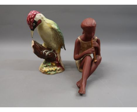 Goldscheider terracotta figure of a seated girl playing a recorder, 8ins high together with a Beswick figure of a woodpecker,