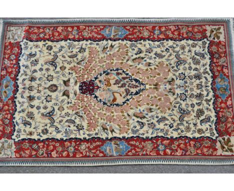 Isfahan part silk rug with a medallion, pictorial and all-over floral design on an ivory ground with red ground borders and c