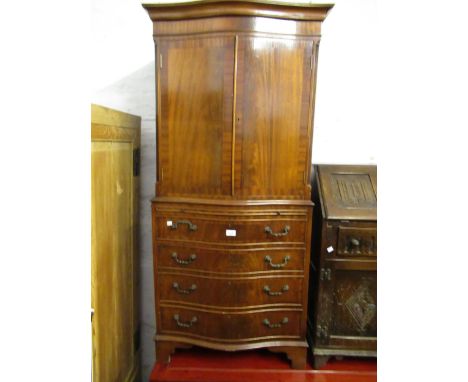 Reproduction mahogany serpentine fronted cocktail cabinet with two panel doors above a pull-out slide, single drawer and cupb