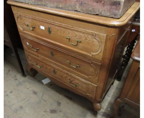 Mid 20th Century French oak bedroom chest on cabriole supports, 38ins wide, together with a pair of matching bedside cabinets
