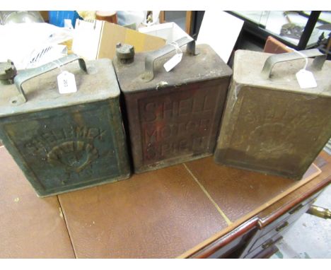 Three vintage petrol cans and various brass caps 